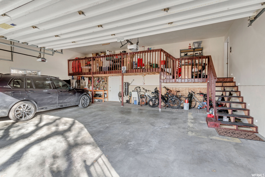 Garage featuring a garage door opener and a workshop area