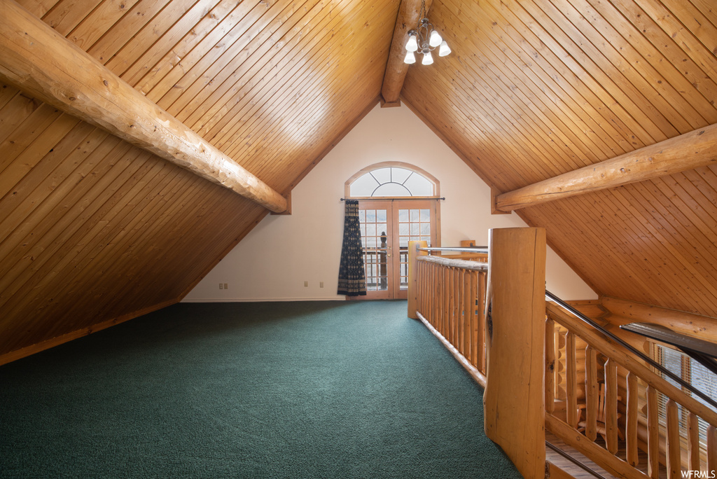 Additional living space featuring wood ceiling, dark carpet, and vaulted ceiling with beams