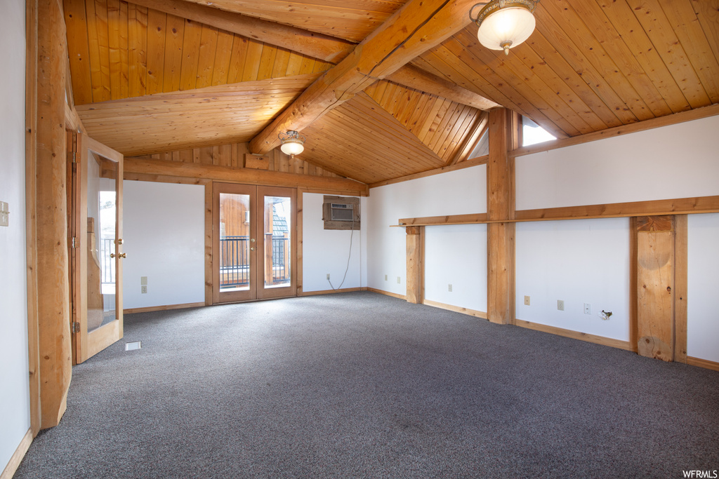 Carpeted empty room with french doors, beamed ceiling, wooden ceiling, and high vaulted ceiling
