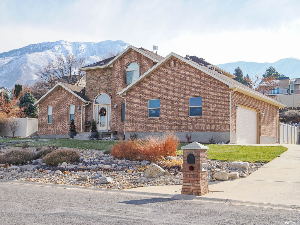 Front of property featuring a garage and a mountain view