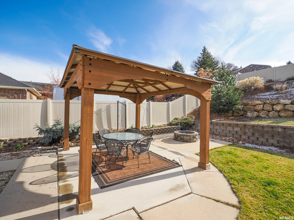 View of patio / terrace featuring a gazebo and an outdoor fire pit