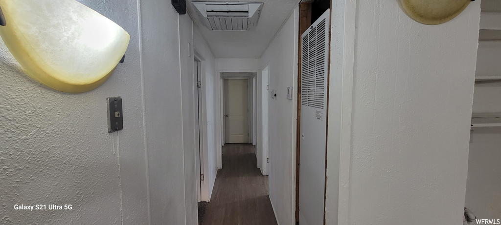 Hallway with hardwood / wood-style flooring