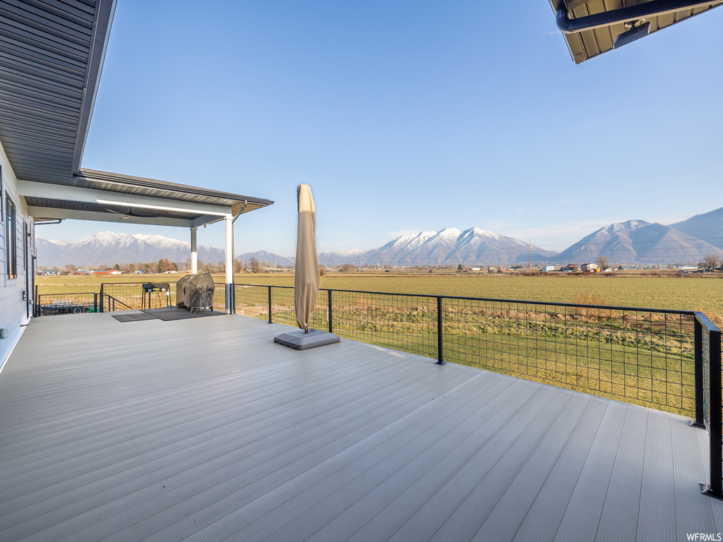 Deck featuring a rural view and a mountain view