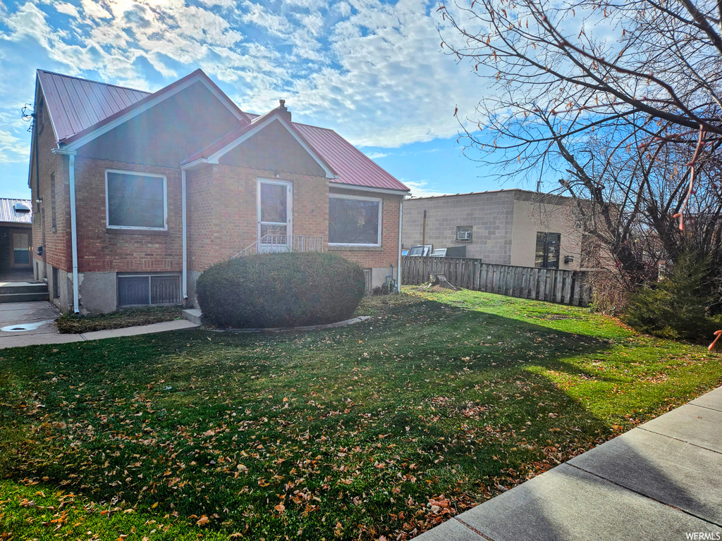 Exterior space featuring a front lawn