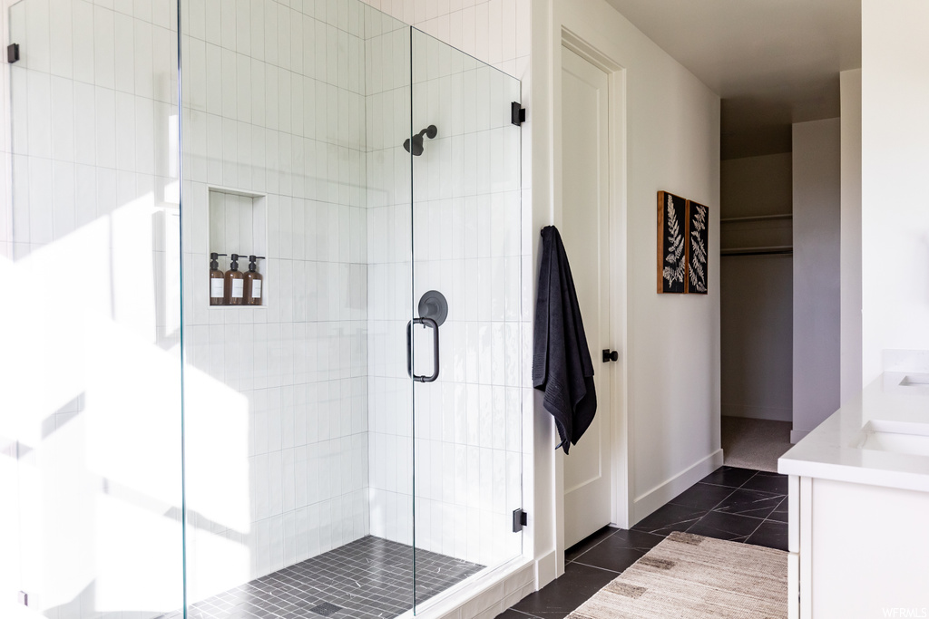 Bathroom with tile flooring and an enclosed shower