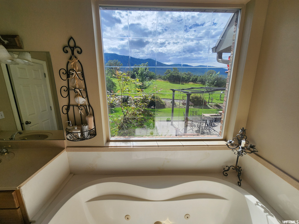 Bathroom with a washtub and a mountain view