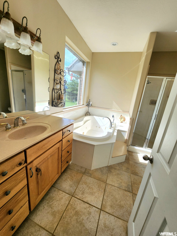 Bathroom with tile flooring, plus walk in shower, and oversized vanity