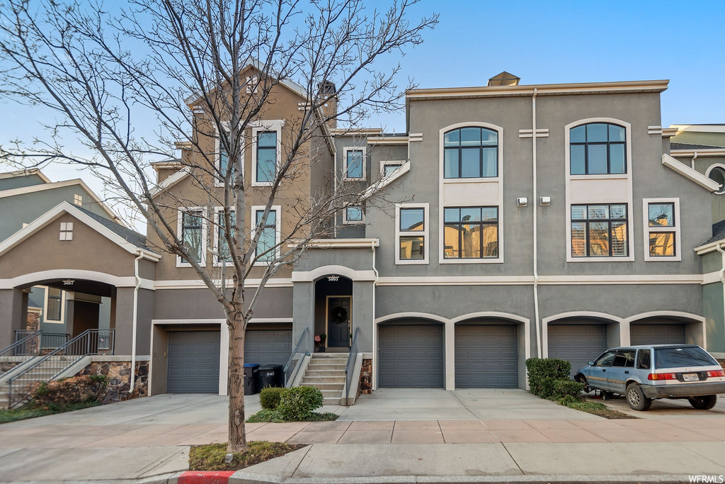 Townhome / multi-family property featuring a garage