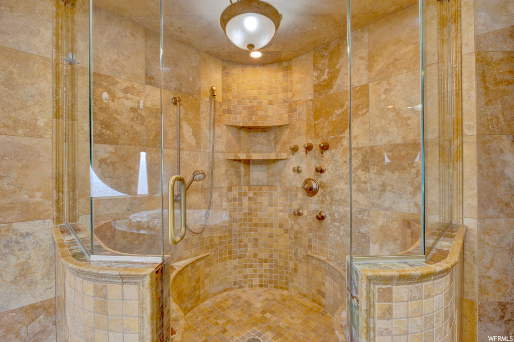 Bathroom with tile walls and walk in shower