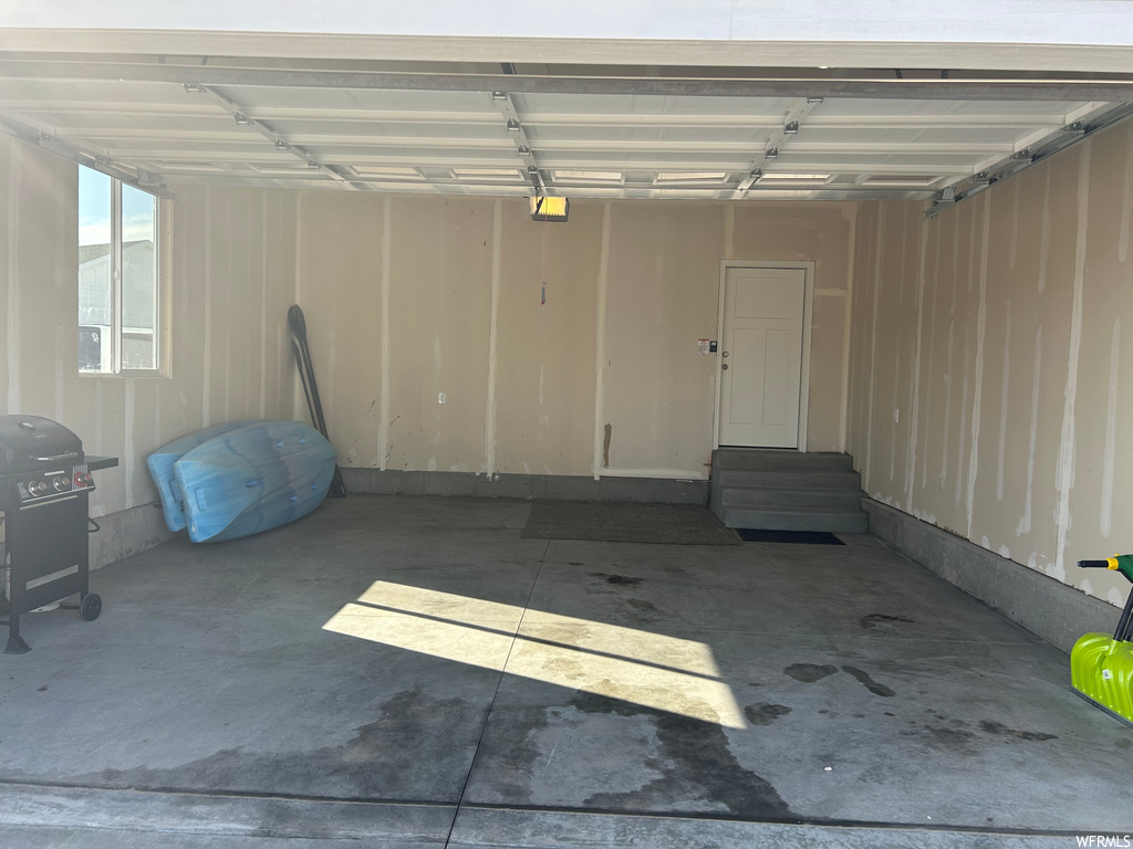 Garage featuring a carport and a garage door opener
