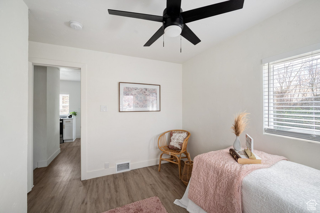 Bedroom featuring multiple windows, ceiling fan, and wood-type flooring
