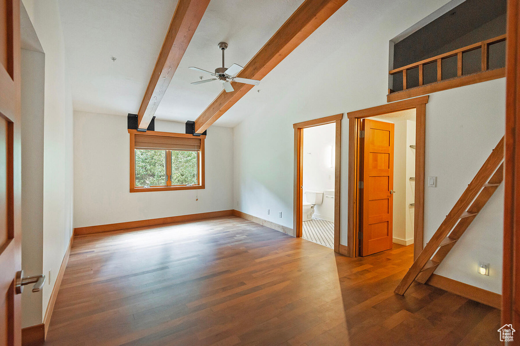 Unfurnished room with ceiling fan, lofted ceiling with beams, and hardwood / wood-style flooring