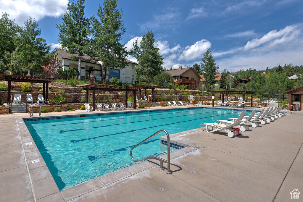 View of swimming pool featuring a pergola