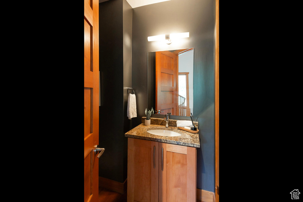 Bathroom with hardwood / wood-style floors and vanity