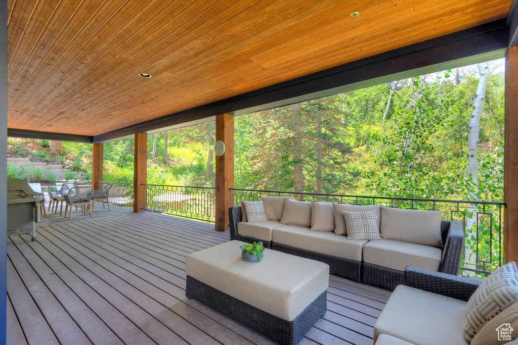 Wooden deck featuring outdoor lounge area