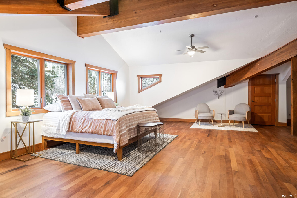 Bedroom with ceiling fan, light wood-type flooring, beam ceiling, and high vaulted ceiling