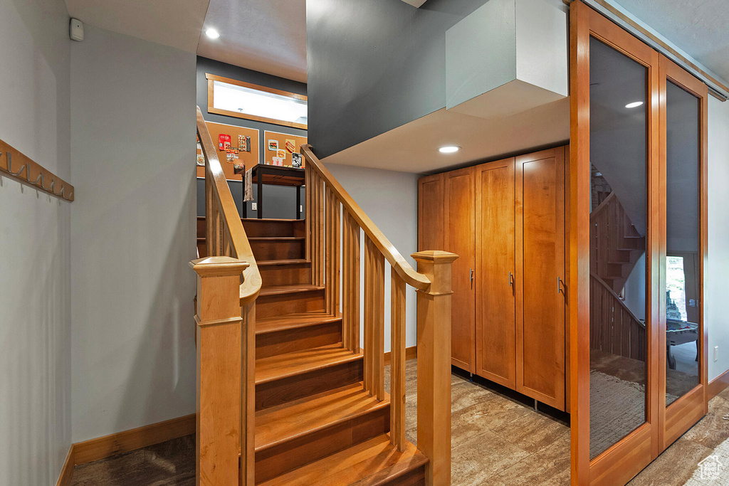 Staircase with light tile floors