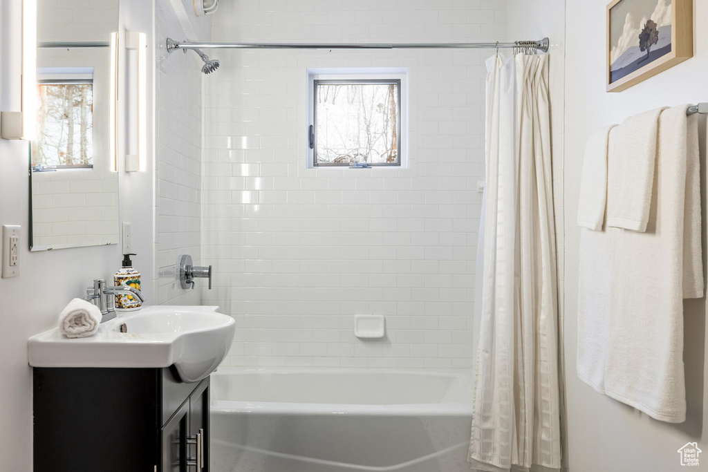 Bathroom featuring shower / bath combo and vanity