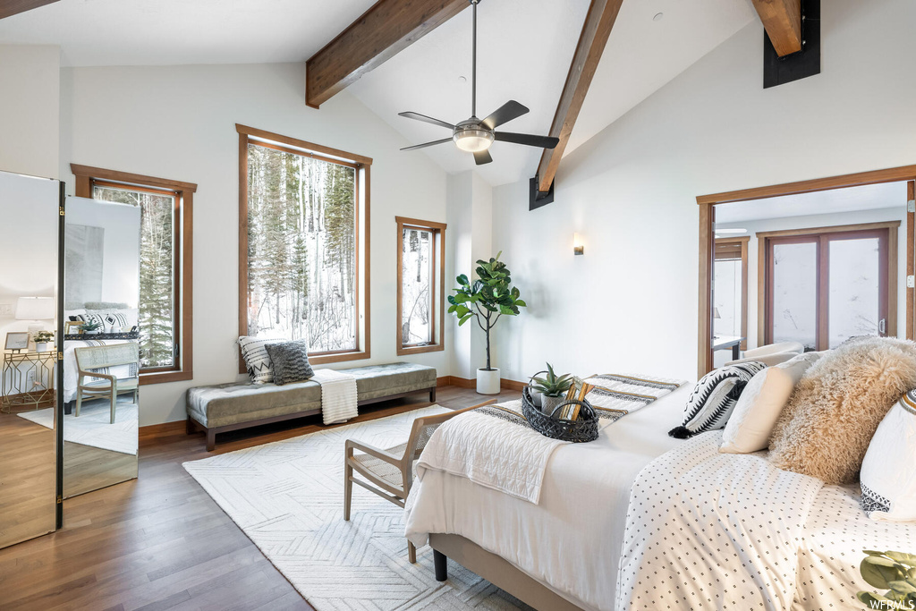 Bedroom with beamed ceiling, ceiling fan, high vaulted ceiling, and light hardwood / wood-style floors