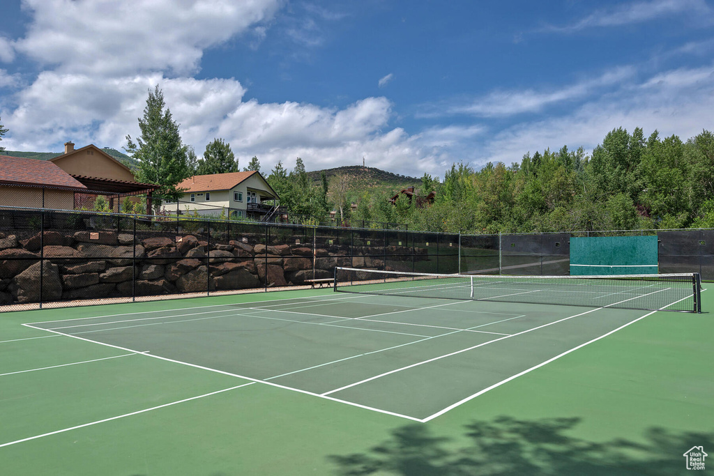 View of tennis court with a mountain view