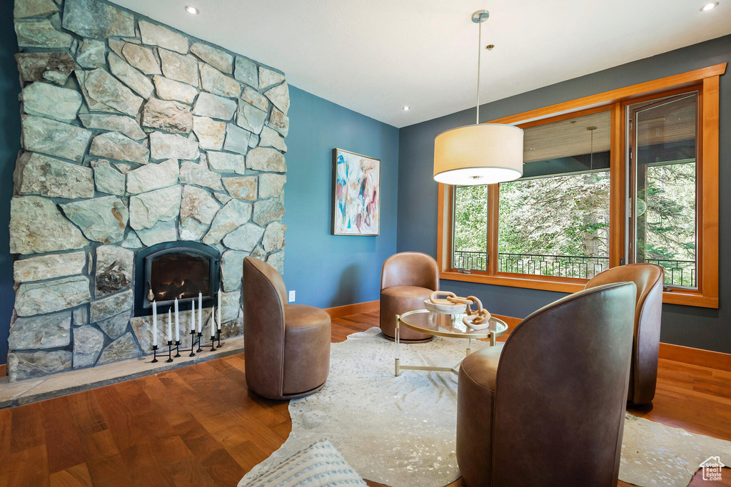 Interior space featuring a stone fireplace and hardwood / wood-style flooring