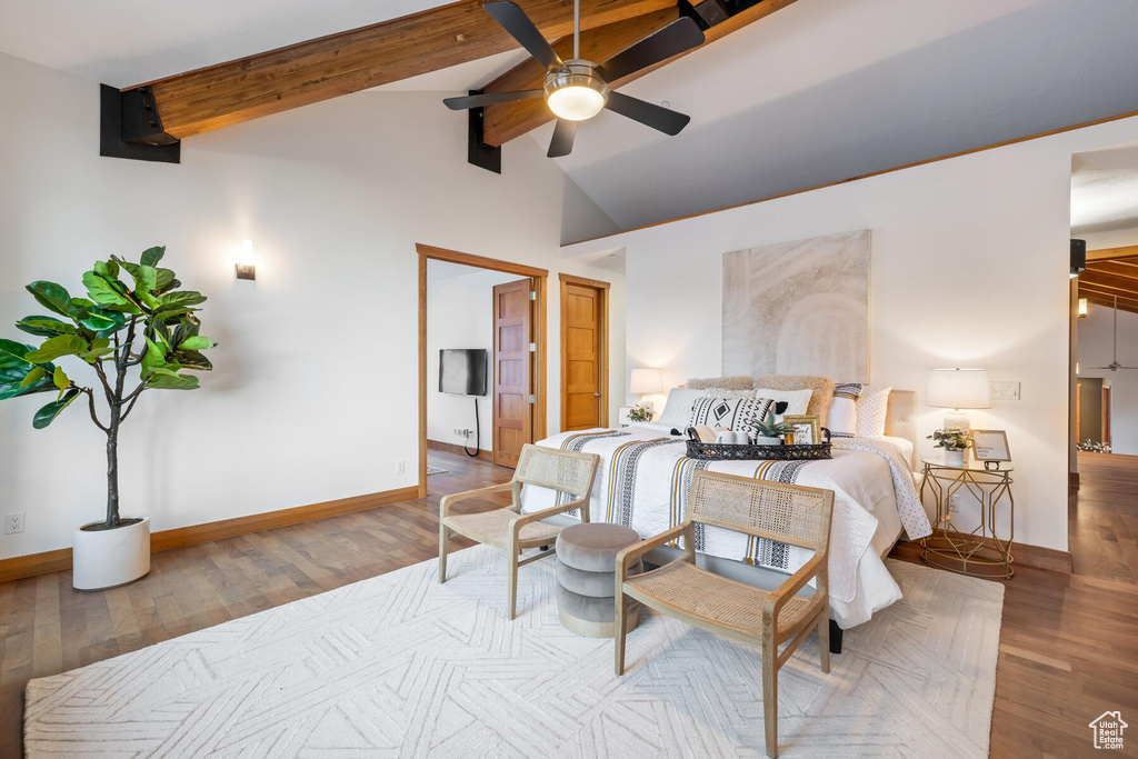 Bedroom with beamed ceiling, high vaulted ceiling, ceiling fan, and hardwood / wood-style floors