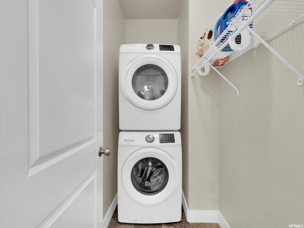 Laundry area featuring stacked washer and clothes dryer