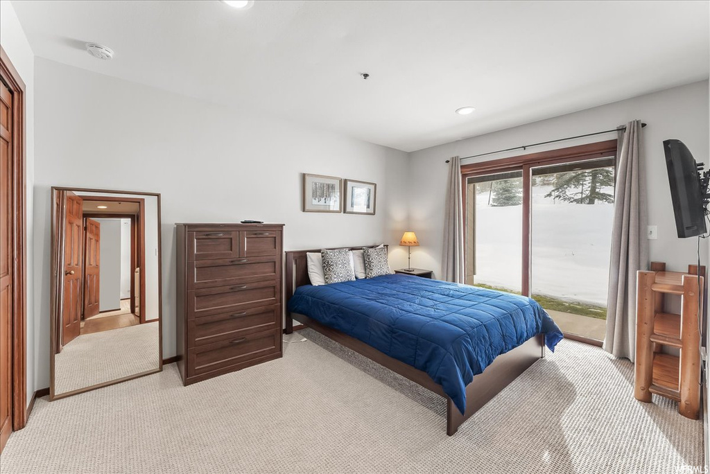 Carpeted bedroom featuring access to outside