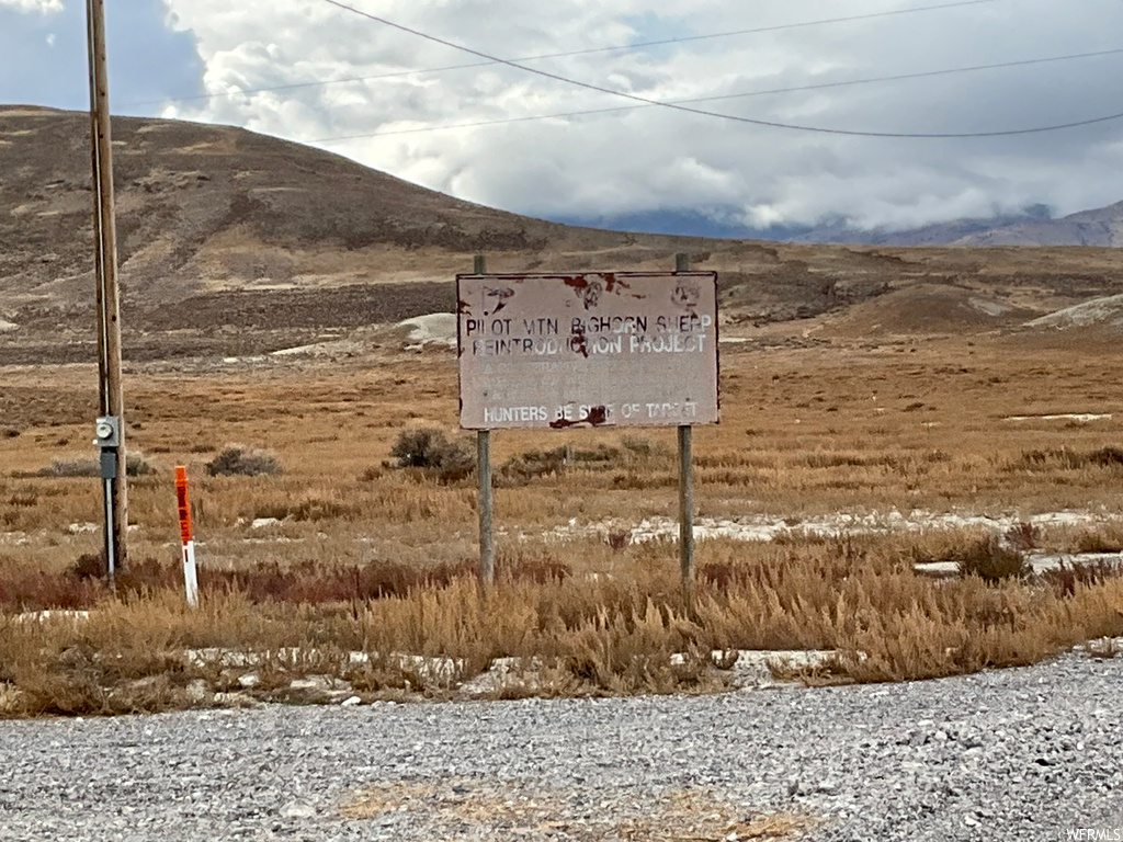 Community sign with a mountain view