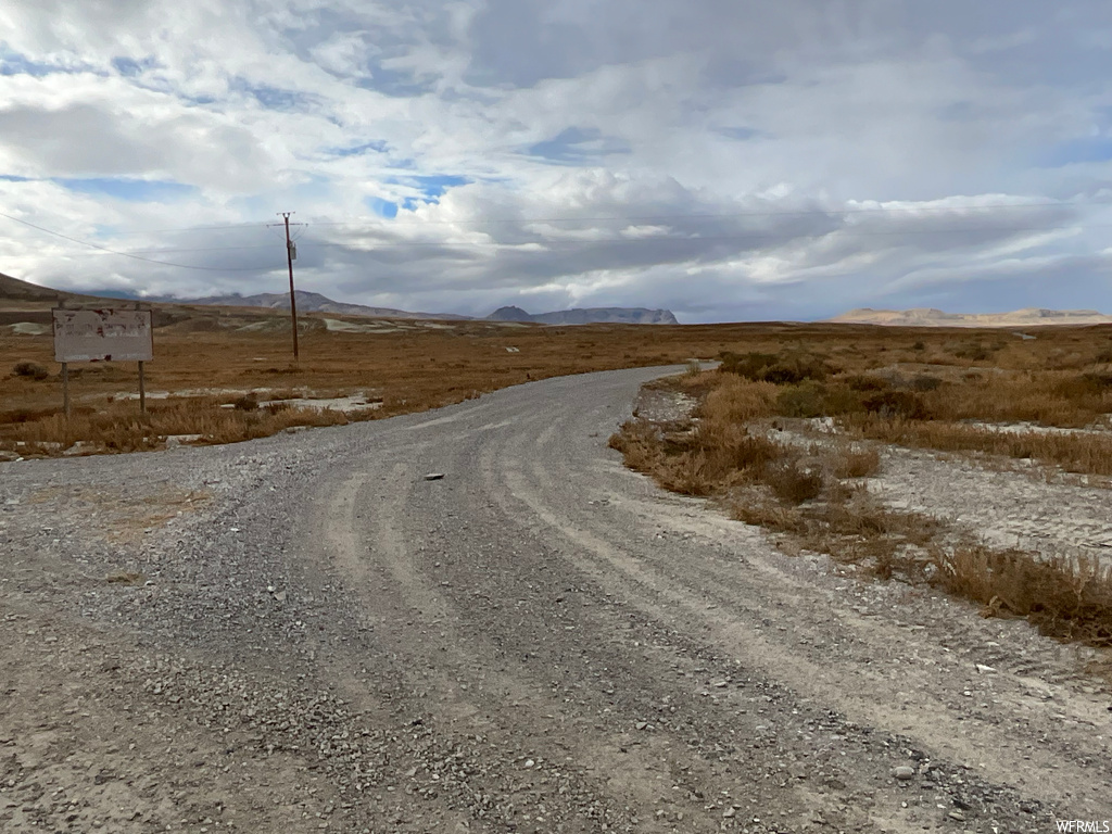 View of road with a rural view and a mountain view