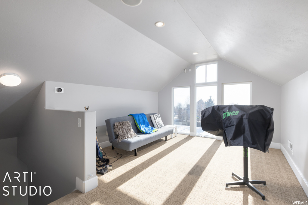 Interior space featuring lofted ceiling and light carpet