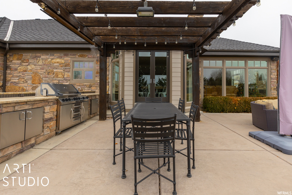 View of terrace featuring a pergola, exterior kitchen, and area for grilling