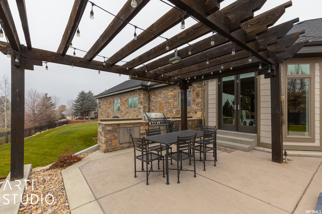 View of patio featuring a pergola, grilling area, and exterior kitchen