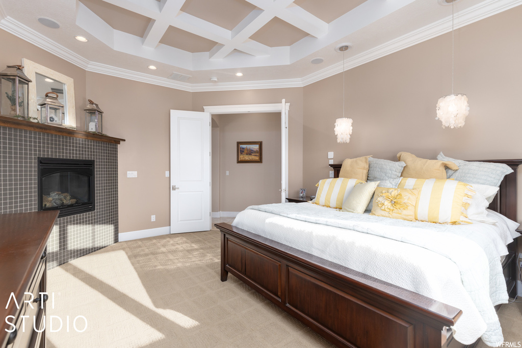 Carpeted bedroom with coffered ceiling, a tile fireplace, crown molding, and beam ceiling