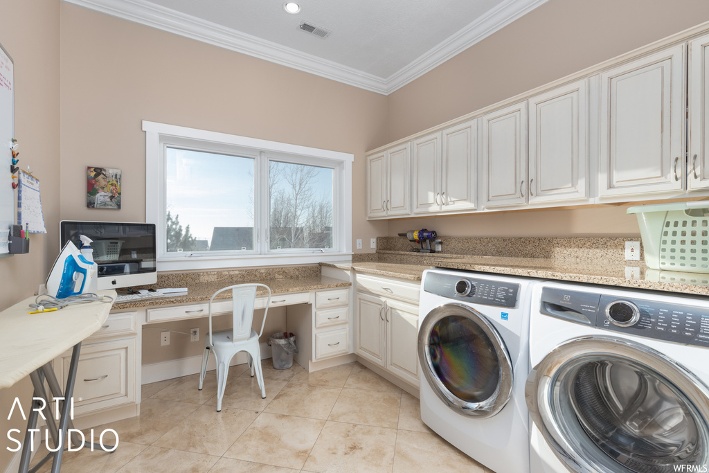 Clothes washing area with independent washer and dryer, cabinets, crown molding, and light tile floors