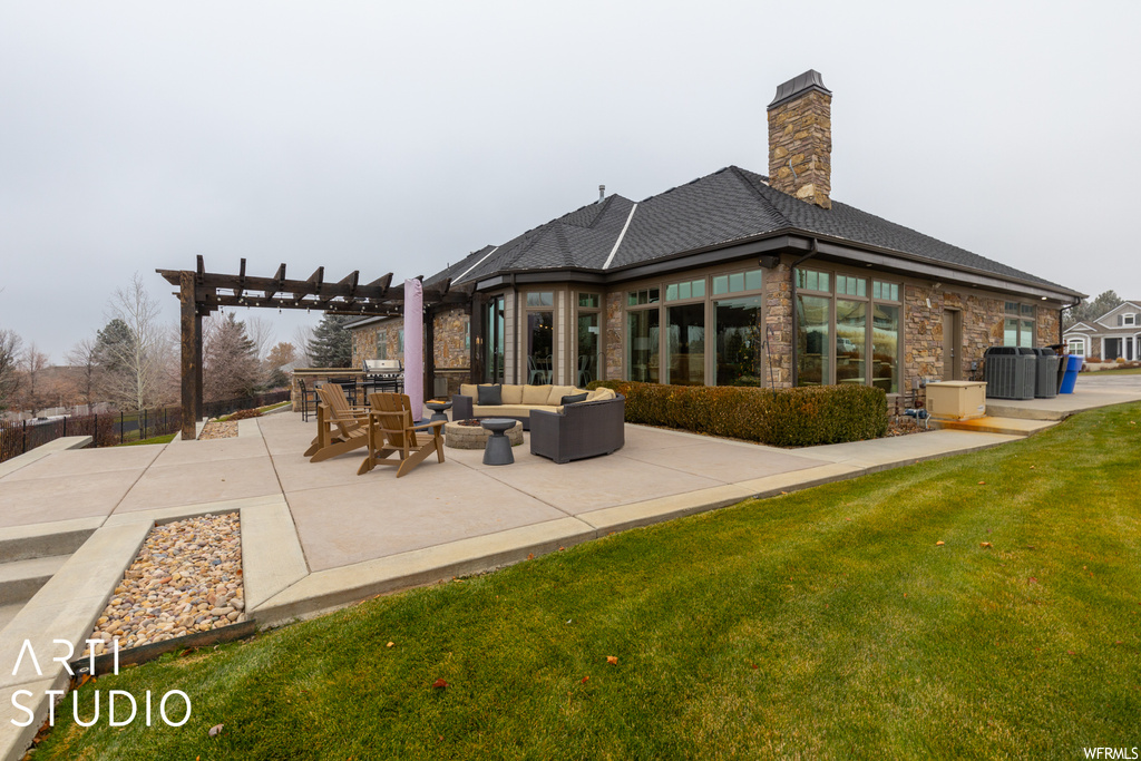 Exterior space featuring a pergola, a patio area, a lawn, and outdoor lounge area
