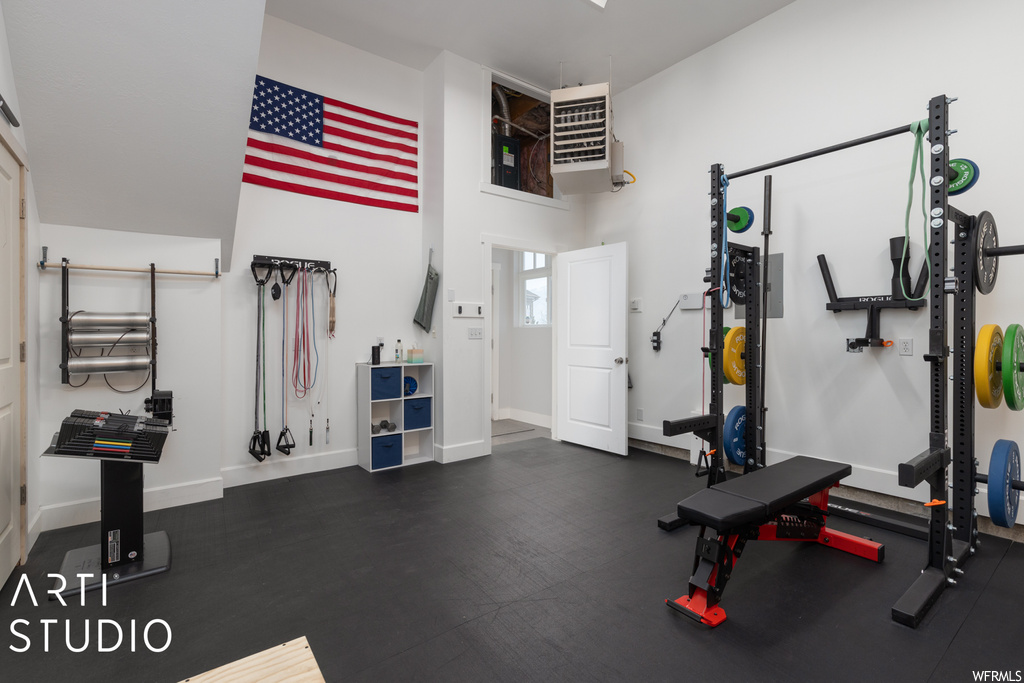 Exercise room with a towering ceiling