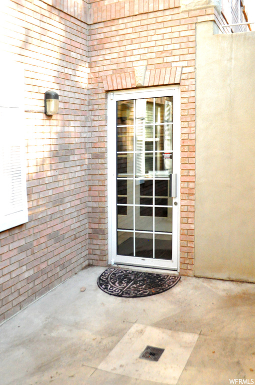 Doorway to property featuring a patio