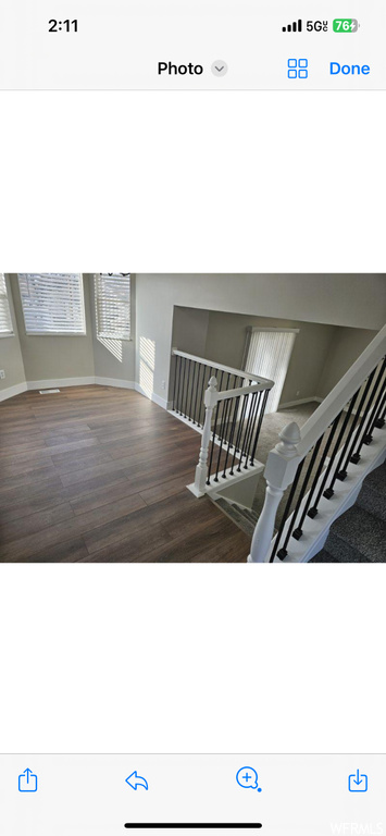 Stairway with dark hardwood / wood-style floors