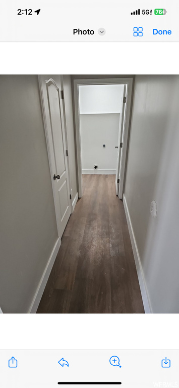 Hall with dark hardwood / wood-style floors