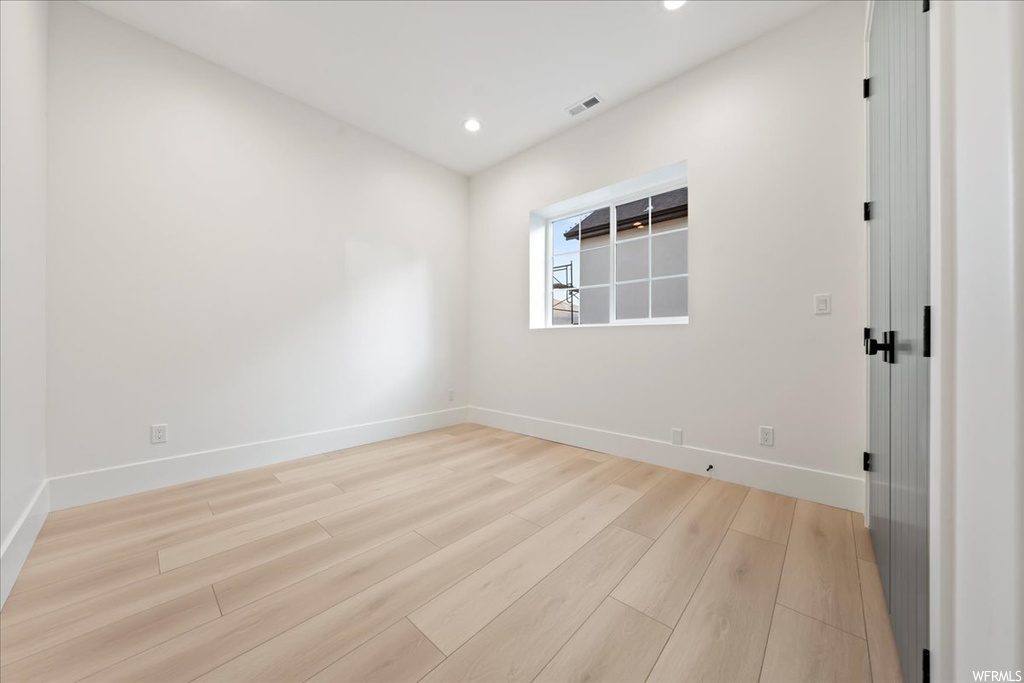 Spare room featuring light wood-type flooring