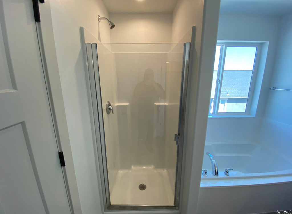 Bathroom featuring plus walk in shower