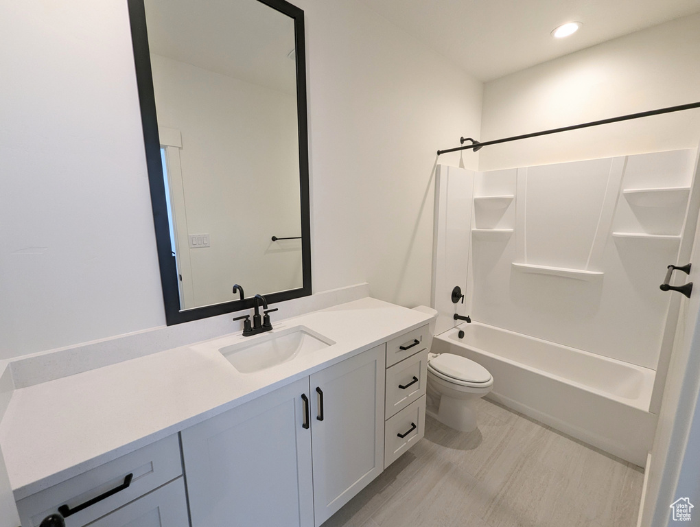Full bathroom with vanity, tub / shower combination, and toilet
