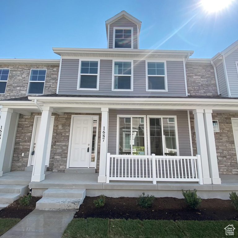 View of property with covered porch