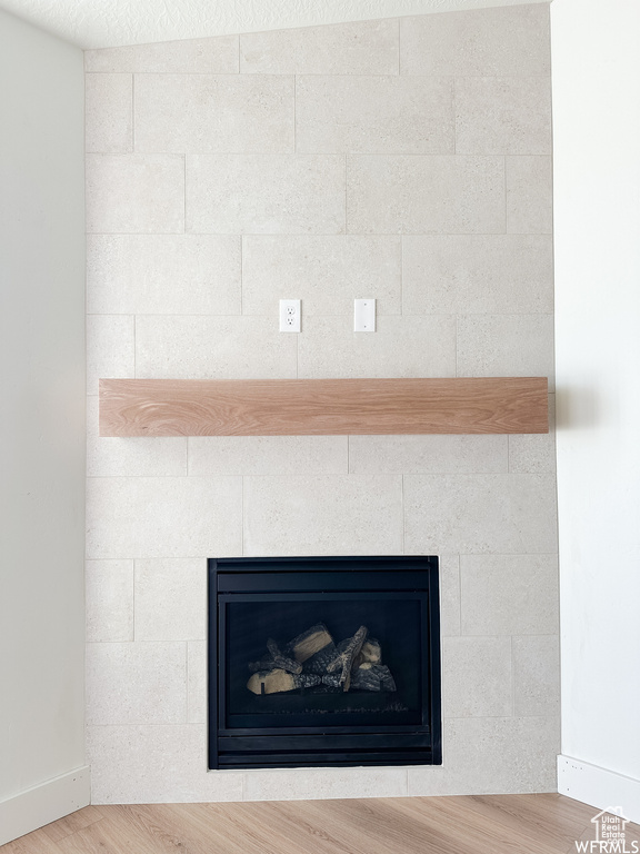 Details featuring a fireplace and light hardwood / wood-style floors