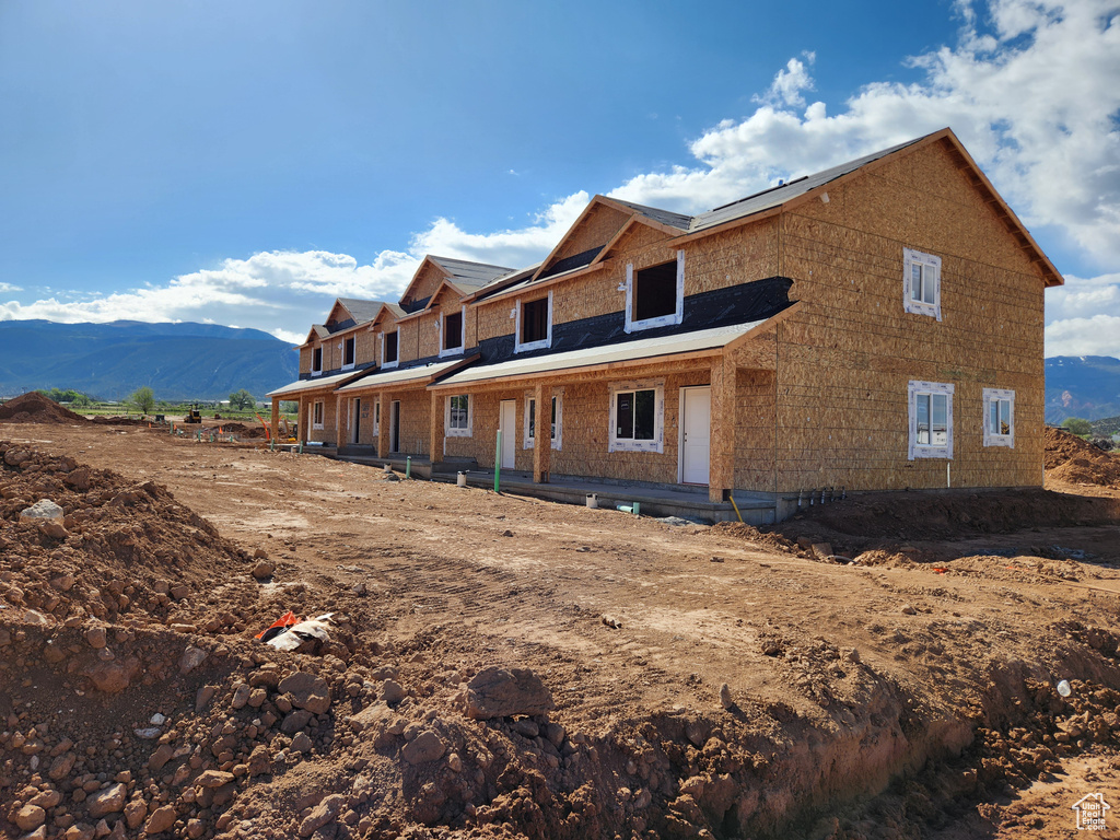 Back of property with a mountain view