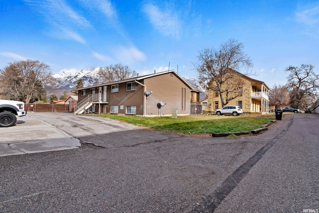 View of front of property featuring a front yard and a mountain view