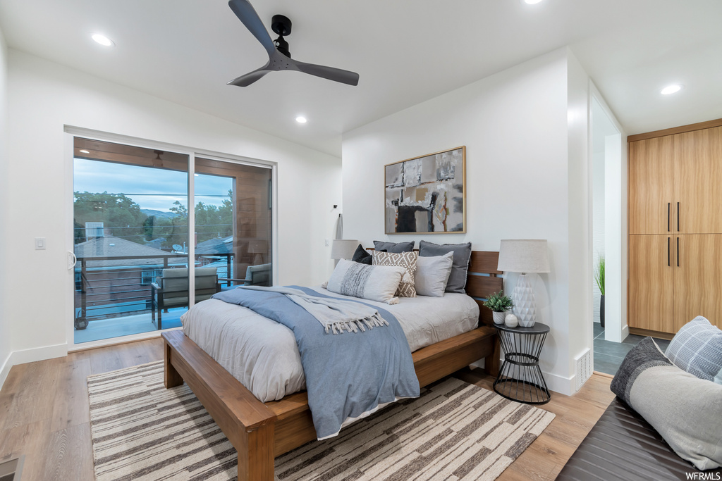 Bedroom featuring ceiling fan, light hardwood / wood-style flooring, and access to exterior