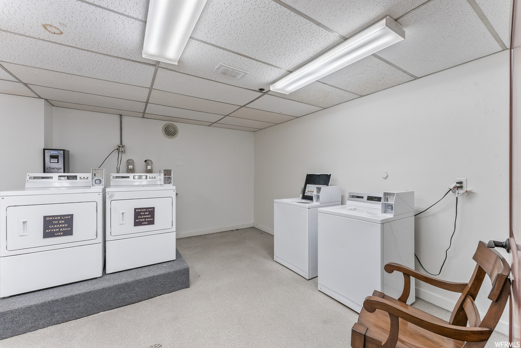 Laundry room with light carpet and washing machine and dryer