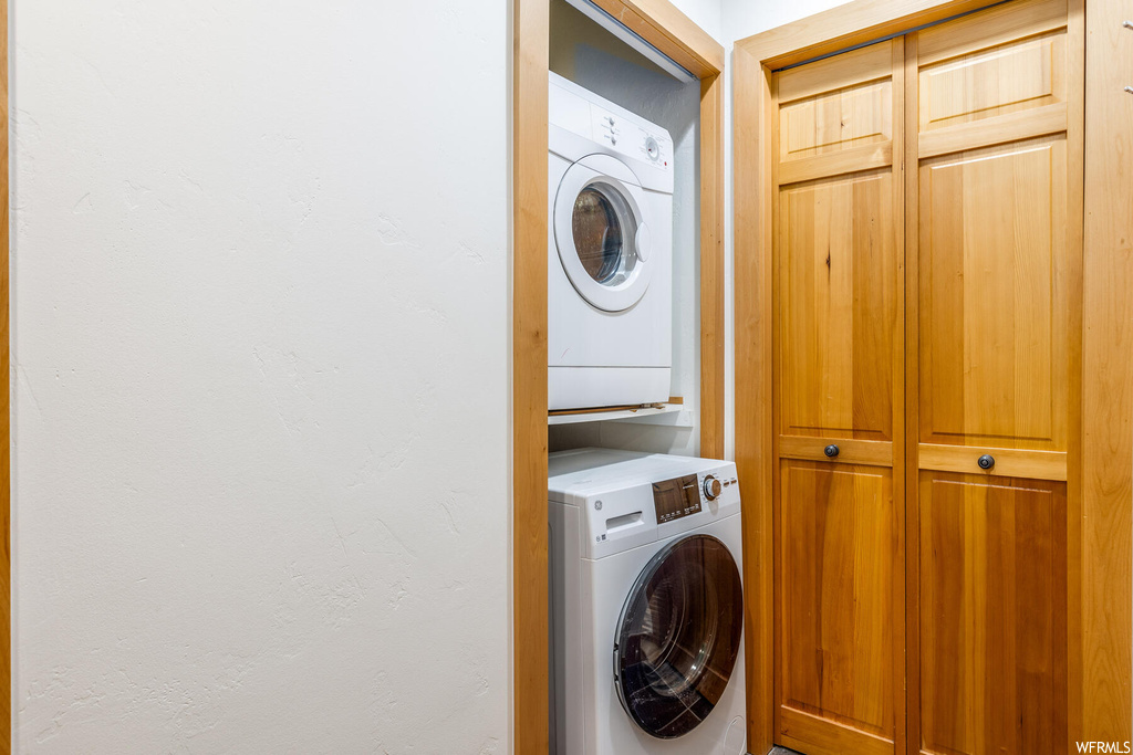 Laundry room featuring stacked washer / dryer